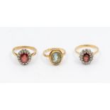 A collection of three 9ct gold stone set rings, to include a garnet and cz oval cluster, size O, a