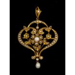 An Art Nouveau seed pearl and gold pendant/brooch, comprising an open work form with floral