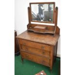 A mid 20th Century oak dressing table, an oak occasional table and a Champion Spark Plug cleaver