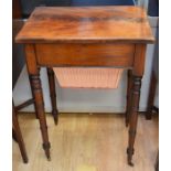 A late Georgian mahogany sewing table / writing table on long turned legs and castors with open
