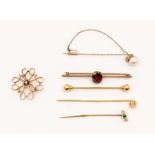 A collection of seven 20th century stick pins/brooches to include a diamond set pin, set with an old