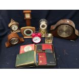 A collection of 20th century mantel clocks, battery-operated clocks and Bibles