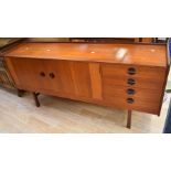 1960s/70s teak sideboard on block legs and with two cupboard doors and four side drawers