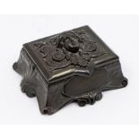 A Victorian Art Nouveau ebony stamp box with vacant cartouche and ornate decoration