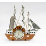 A nautical style clock in the shape of a sailing boat. A 4" dial electric movement. All in a sailing