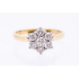 A diamond and 18ct gold cluster ring, comprising a flower head set with round brilliant cut