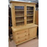 A modern antique pine glazed kitchen cabinet with three base drawers and a single cupboard door