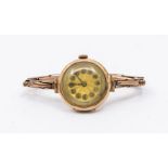 An early 20th century ladies 9ct gold wristwatch, comprising a guilloche dial with Arabic number