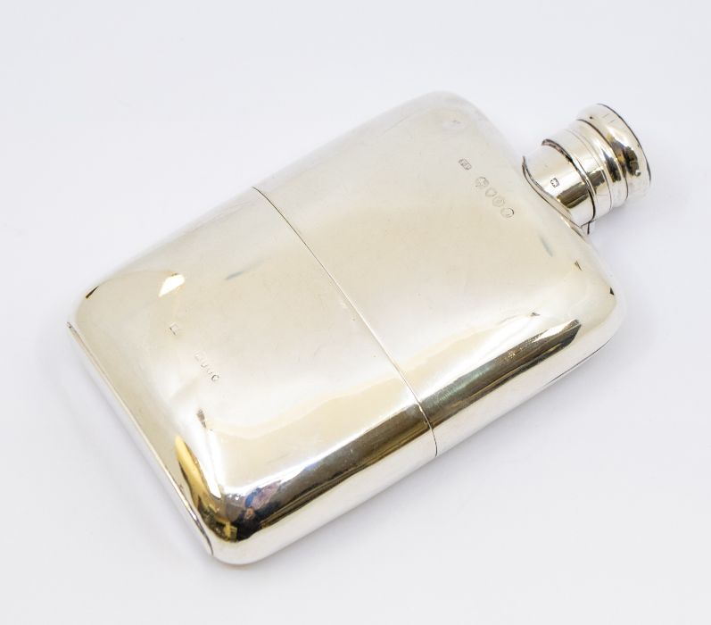 A Victorian silver spirit flask with plain design and detachable cup and hinged top, gilt interior