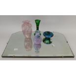 A collection of moulded glass, silver-topped perfume bottles, coloured glass condiments etc, also