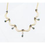 A sapphire and diamond set 14ct gold necklet, comprising alternate sapphire drops each with a top