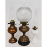 Three brass Edwardian oil lamps with funnels and one shade