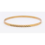 An 18ct gold narrow bangle with  engraved decoration, width approx 3mm, internal diameter approx