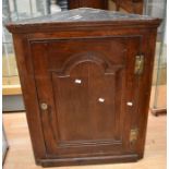 A George III oak corner cabinet