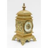 A late 19th to early 20th century German brass 8-day mantel clock with Arabic numerals and finial