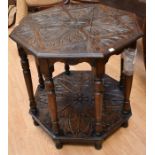 A late 19th century carved oak occasional table with two heavily carved leaves
