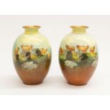 A pair of Royal Doulton hand painted vases depicting sheep in landscape, with gilt detail and