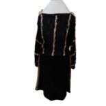 An unusual knitted two piece from the late 1970s/early 1980s, in black knit, the skirt is knee