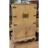 A mid 20th century bleached wood cocktail cabinet, Chinese style, with brass detail and carved base