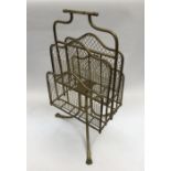 A brass Canterbury. With tripod base and 3 lion’s paw feet. Revolving design, with 4 brass mesh