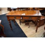 A late Victorian mahogany two-drawer lady's writing desk with turned legs