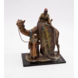 A novelty cold painted spelter table lighter of two Arab figures and camel, various colours and on
