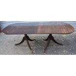 A reproduction George III mahogany D-end dining table with a wide single leaf and set on splayed