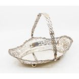 A George V silver basket with ornate pierced work to bordering, and handle, with ball feet to