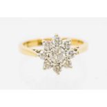 A diamond and 14ct gold ring, comprising a flower cluster of round brilliant cut diamonds, the