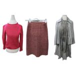 A full lined pencil skirt in a colourway of mauve/pink/burgundy in a zigzag pattern, kick pleat at