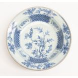 A Chinese export blue and white bowl, decorated with magnolia tree to centre within geometric