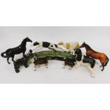 A collection of Beswick horses and other Staffordshire dogs