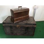A large iron and leather bound trunk with material innards and iron work to handles to sides,