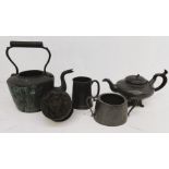 A large collection of 19th century pewter, including measures, teapots and a large Victorian lion'