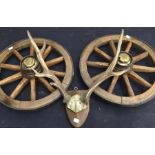 Two wooden cart wheels, antlers, vintage snares and vintage cutting tool with wooden handle