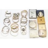 A collection of silver bangles to include hinged and torque versions, various designs and sizes,