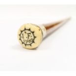 An 18th century fruitwood and ivory walking cane, the ivory pommel with pique work decoration,