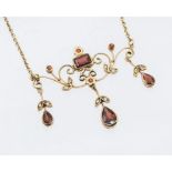 A garnet and diamond 9ct gold Edwardian style necklace, the centre set with a rectangular cut garnet