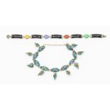 A coloured jade and silver set bracelet, comprising black black panels with various coloured oval