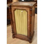 A mid 19th century, single door, glazed cabinet in mahogany with walnut column supports and front