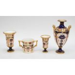 A Royal Crown Derby 1128: twin-handled vase, two posy vases, and a loving cup