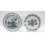 An 18th Century English Delft charger, the centre decorated with flowers and canes, within a band of