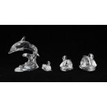Four Swarovski crystal figures - with boxes. Three swans, small, medium and large plus a dolphin.