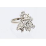 A diamond and 18ct white gold cluster ring, comprising a principal round brilliant cut diamond to