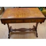 A 20th century reproduction walnut sofa table with two drop-ends and two front drawers