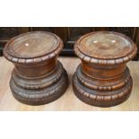 A pair of late 19th to early 20th century round mahogany plinths