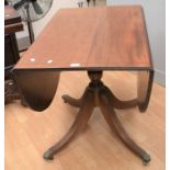 A reproduction mahogany drop-leaf breakfast table. Legs have been repaired and would benefit from