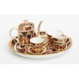 A Royal Crown Derby 1128 "Old Imari" miniature tea set within original cellophane packaging and