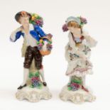 A pair of late 19th to early 20th century Continental porcelain figurines of fruit sellers.