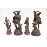 A pair of spelter figures of classical soldiers on stands, along with two other early 20th century